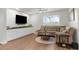 The living room has an accent wall, large windows, and a ceiling fan at 2572 Garden Plum Pl, Odessa, FL 33556