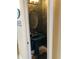 Stylish powder room featuring a pedestal sink and decorative mirror at 2880 Chelsea N Pl, Clearwater, FL 33759