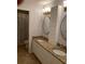 Bathroom with double sinks, granite countertops, and decorative mirrors at 2880 Chelsea N Pl, Clearwater, FL 33759