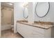 Bright bathroom features dual sinks with granite countertops and a shower and bathtub combo at 2880 Chelsea N Pl, Clearwater, FL 33759