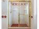A well lit shower with gold trim and red accents at 2880 Chelsea N Pl, Clearwater, FL 33759