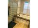 Bright bathroom featuring a glass block shower wall, and granite countertop at 2880 Chelsea N Pl, Clearwater, FL 33759
