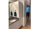 Bathroom vanity with granite countertop, white cabinets, and tile flooring at 2880 Chelsea N Pl, Clearwater, FL 33759