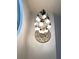 Striking chandelier illuminates the space, creating a focal point of elegance and charm at 2880 Chelsea N Pl, Clearwater, FL 33759