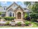 Close up of the entryway showing the stone archway and immaculate landscaping at 2880 Chelsea N Pl, Clearwater, FL 33759