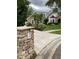 View of house exterior with stone mailbox in the yard at 2880 Chelsea N Pl, Clearwater, FL 33759