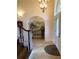 Inviting foyer with tile flooring, arched doorway, and decorative chandelier at 2880 Chelsea N Pl, Clearwater, FL 33759