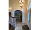 Inviting foyer with tile flooring, arched doorway, and decorative chandelier at 2880 Chelsea N Pl, Clearwater, FL 33759
