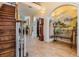Spacious foyer with staircase, decorative bench, and tile flooring that leads into the home at 2880 Chelsea N Pl, Clearwater, FL 33759