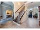 Open foyer with staircase, tile flooring, and views into the dining and living areas at 2880 Chelsea N Pl, Clearwater, FL 33759