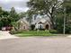 Charming stone and stucco home with mature landscaping and a well-manicured front lawn at 2880 Chelsea N Pl, Clearwater, FL 33759