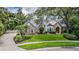 Beautiful two-story home with lush front lawn and a circular driveway at 2880 Chelsea N Pl, Clearwater, FL 33759