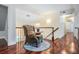 Hallway with an ornate armchair, hardwood floors, a bannister, and stairs at 2880 Chelsea N Pl, Clearwater, FL 33759