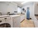 Well-organized laundry room with modern washer, dryer and built-in cabinets at 2880 Chelsea N Pl, Clearwater, FL 33759