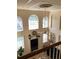 Upstairs view of the living room featuring large windows and a cozy fireplace at 2880 Chelsea N Pl, Clearwater, FL 33759
