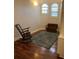 Cozy living room with rocking chair, wooden flooring and a patterned rug at 2880 Chelsea N Pl, Clearwater, FL 33759