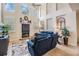 Inviting living room with vaulted ceilings, fireplace, and stylish blue seating arrangement at 2880 Chelsea N Pl, Clearwater, FL 33759