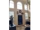 Bright living room featuring a fireplace, windows, and high ceilings at 2880 Chelsea N Pl, Clearwater, FL 33759