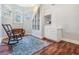 Study with a rocking chair, a blue rug, hardwood floors, and built-in shelves and cabinets at 2880 Chelsea N Pl, Clearwater, FL 33759