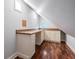 Office or bonus room with hardwood floors, white cabinets, and a desk at 2880 Chelsea N Pl, Clearwater, FL 33759