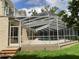A beautiful screened-in pool with a luxurious architectural structure over the pool area at 2880 Chelsea N Pl, Clearwater, FL 33759