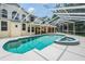 Large screened pool and spa with ample deck space and a covered patio area with outdoor cooking capabilities at 2880 Chelsea N Pl, Clearwater, FL 33759