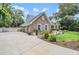 Stone-clad home with three-car garage, well-maintained landscaping and inviting driveway at 2880 Chelsea N Pl, Clearwater, FL 33759