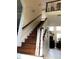 Elegant staircase with wooden steps and white railing, leading to a landing at 2880 Chelsea N Pl, Clearwater, FL 33759