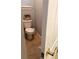 Small powder room area with toilet, tile floor, and neutral wall color at 2880 Chelsea N Pl, Clearwater, FL 33759