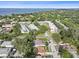 Picturesque aerial view showcasing neighborhood, lush trees, and community pool at 2887 Cathy Ln, Clearwater, FL 33760
