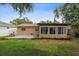 Backyard featuring a concrete patio, landscaping, and greenery at 2887 Cathy Ln, Clearwater, FL 33760
