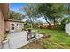 Green backyard with concrete patio, ideal for relaxing and entertaining at 2887 Cathy Ln, Clearwater, FL 33760