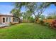 A spacious backyard featuring a concrete patio and lush landscaping at 2887 Cathy Ln, Clearwater, FL 33760