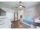 Comfortable bedroom with vinyl floors and ceiling fan plus a view of living space at 2887 Cathy Ln, Clearwater, FL 33760