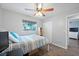 Bedroom featuring wood-look floors, ceiling fan, and closet for convenient storage at 2887 Cathy Ln, Clearwater, FL 33760