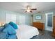 Bedroom view, with wood-look floors, ceiling fan, dresser, and accessible ensuite bathroom at 2887 Cathy Ln, Clearwater, FL 33760