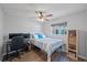 Cozy bedroom with wood-look floors, ceiling fan, and window for natural light at 2887 Cathy Ln, Clearwater, FL 33760