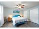 Bright bedroom featuring a ceiling fan, modern vinyl flooring, and closet for ample storage space at 2887 Cathy Ln, Clearwater, FL 33760