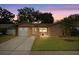 Charming single-story home with a well-maintained lawn, driveway, and attached one-car garage at 2887 Cathy Ln, Clearwater, FL 33760