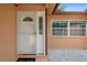 Inviting entryway with decorative front door, sidelight, and 'welcome' mat at 2887 Cathy Ln, Clearwater, FL 33760