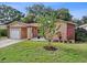 Well-maintained lawn, a one-car garage, and a private driveway, complemented by colorful landscaping at 2887 Cathy Ln, Clearwater, FL 33760