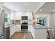 Bright kitchen features white cabinets, stainless steel appliances, breakfast bar with seating at 2887 Cathy Ln, Clearwater, FL 33760