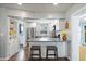 Bright kitchen features white cabinets, stainless steel appliances, breakfast bar with seating at 2887 Cathy Ln, Clearwater, FL 33760