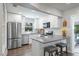 Bright kitchen features white cabinets, stainless steel appliances, breakfast bar with seating at 2887 Cathy Ln, Clearwater, FL 33760