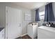 Convenient laundry room with washer, dryer, and ample storage space at 2887 Cathy Ln, Clearwater, FL 33760