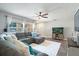 Comfortable living room featuring a sectional sofa, large windows, and a ceiling fan at 2887 Cathy Ln, Clearwater, FL 33760