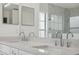 Bathroom with dual sink vanity, large mirrors and marble countertops at 3312 Blythe Ave, Spring Hill, FL 34609