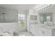 Elegant bathroom featuring marble tile, glass shower, and a dual sink vanity at 3312 Blythe Ave, Spring Hill, FL 34609