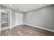 A bedroom featuring gray walls, wood floors, closet, and a light-filled window at 3312 Blythe Ave, Spring Hill, FL 34609