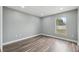 Bedroom with wood-look flooring and a window with a view of the outdoors at 3312 Blythe Ave, Spring Hill, FL 34609
